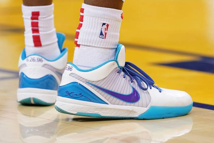 View of white, teal, and purple Nike Kobe shoes.